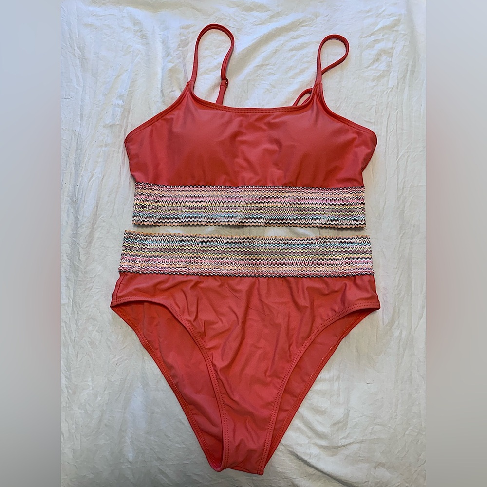 Women’s coral two-piece swimsuit with colorful striped bands on top and bottom!